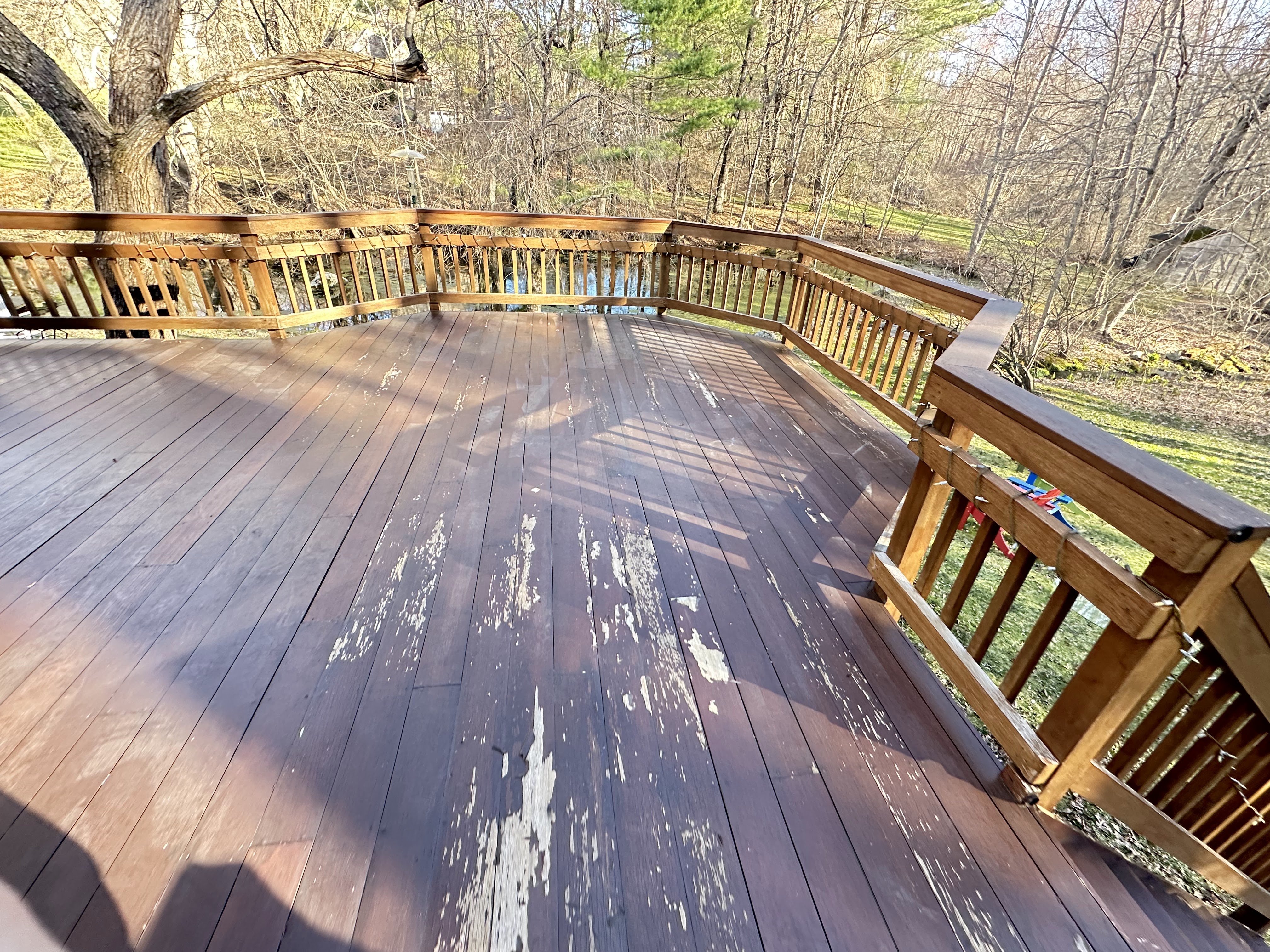 Deck staining in Massachusetts with even coverage on boards and railings