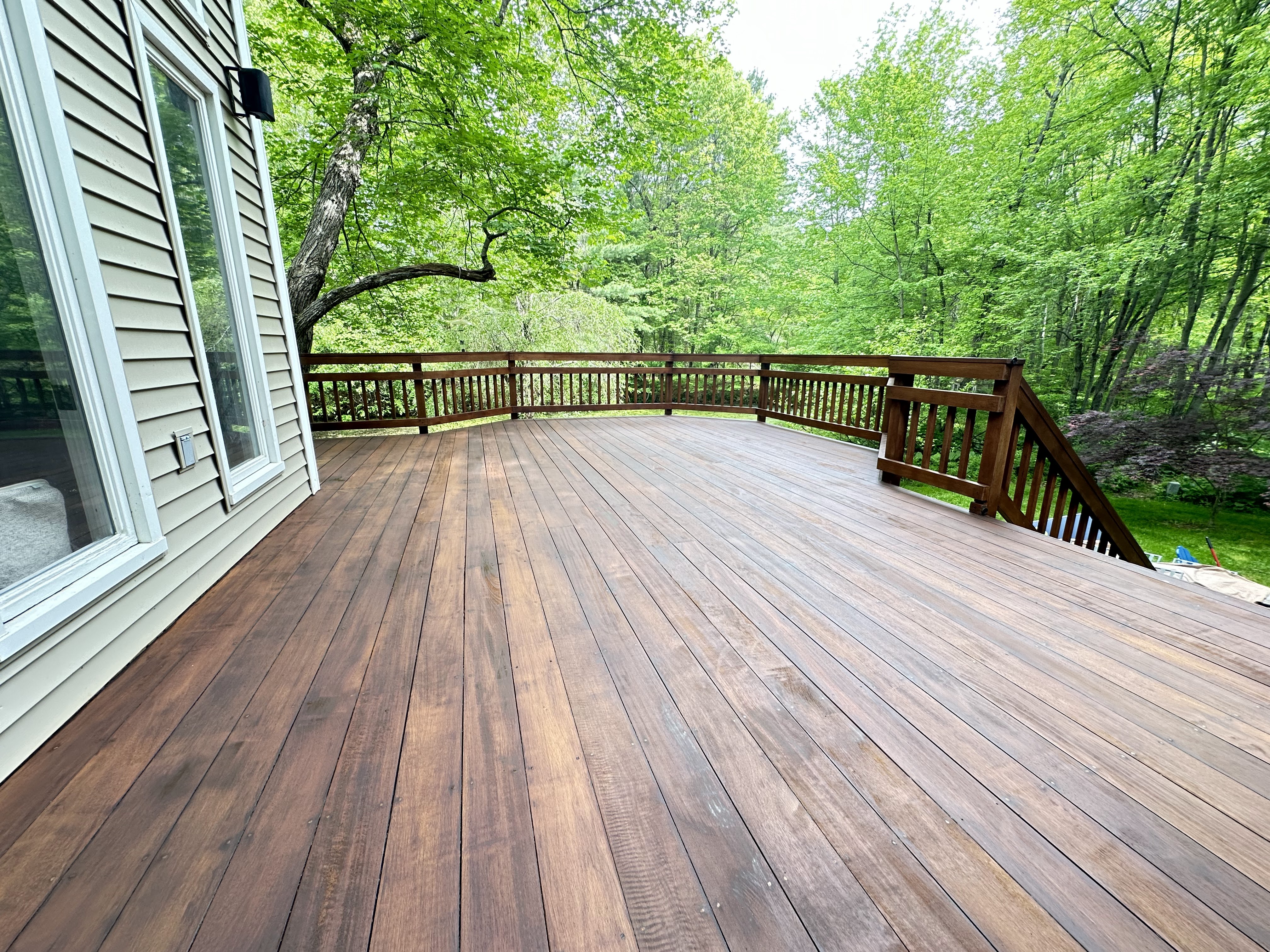 Deck refinishing result with consistent sheen and uniform exterior coverage