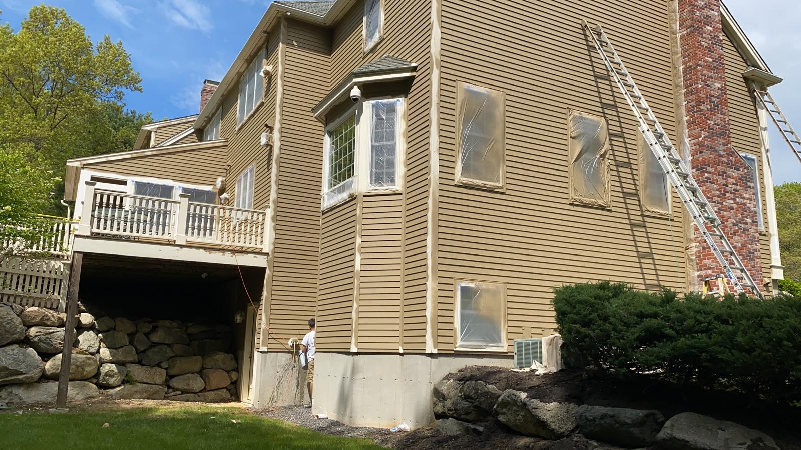 Exterior repaint showing updated color scheme and even coverage on siding