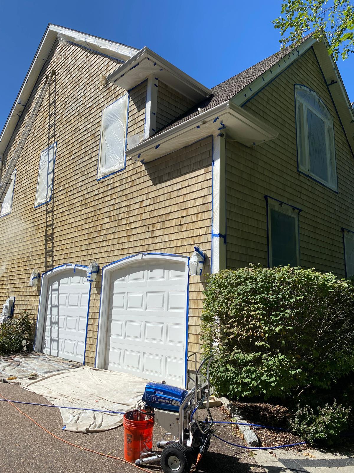Masking and protection during exterior painting project for clean transitions
