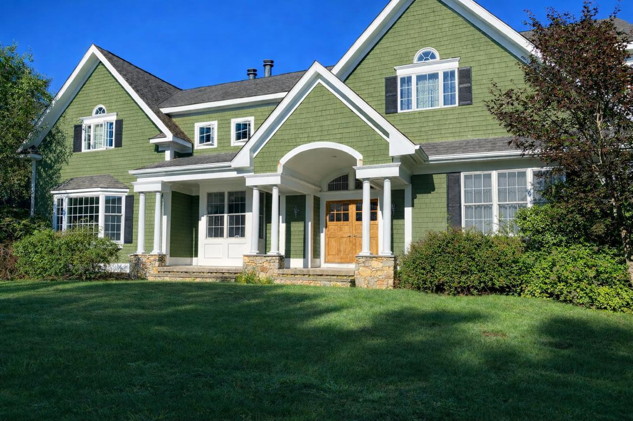 Exterior house painting project with fresh siding and trim