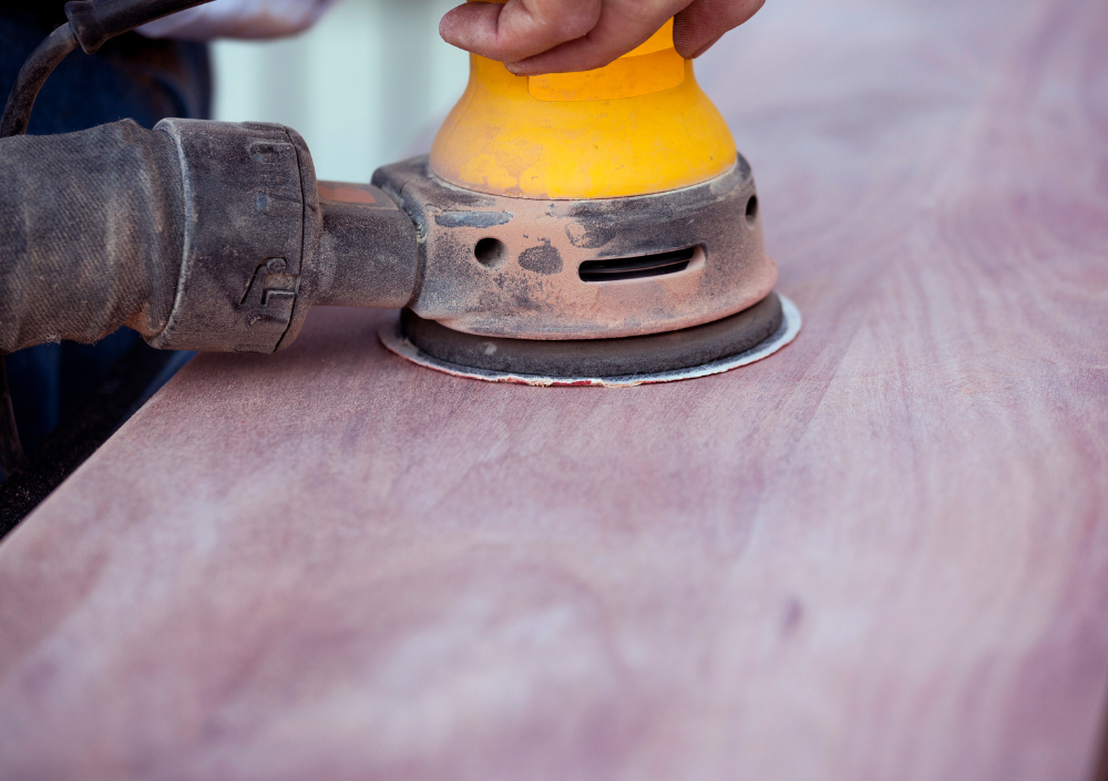 Carpenter repairing wood trim and preparing surfaces for painting