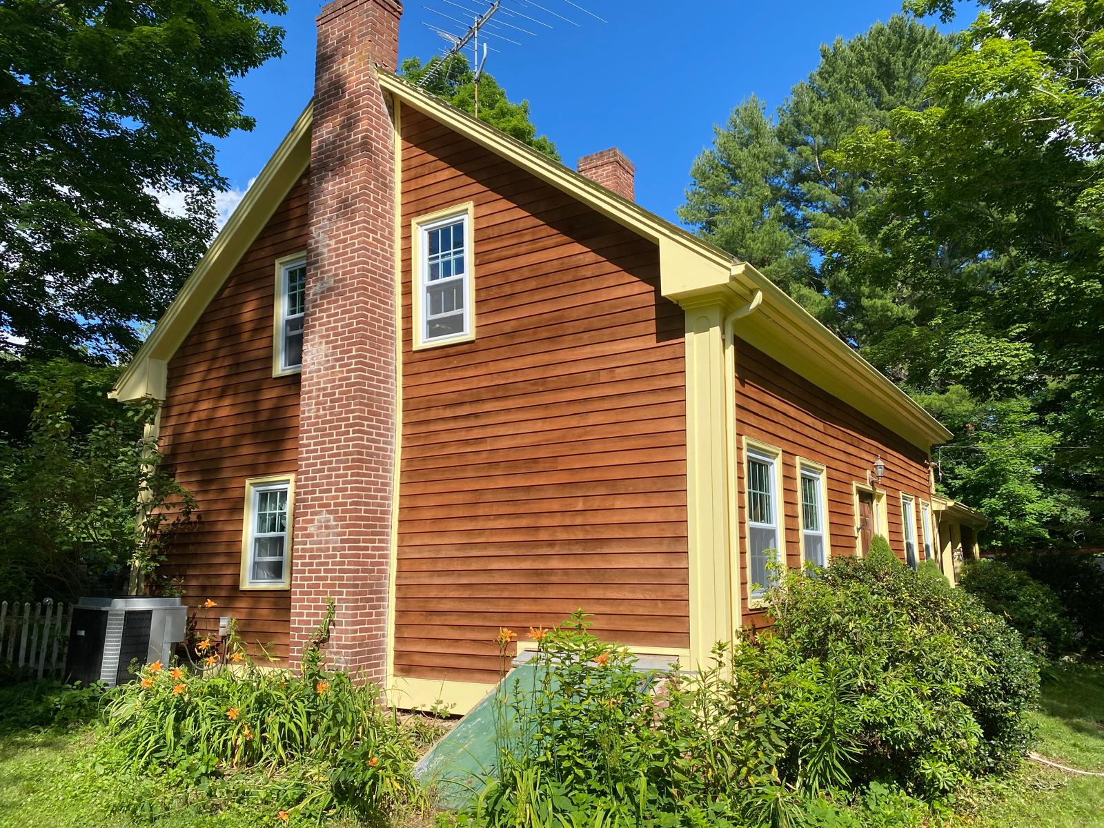 Fence staining project with uniform natural wood tone